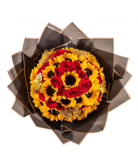 A Ramo Buchón with 25 sunflowers and 26 red roses, hand-tied with tissue paper, and keepsake butterflies.